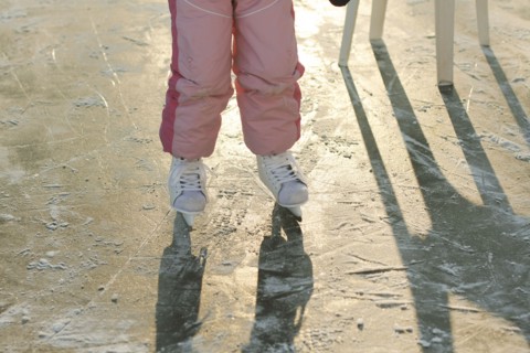 Caucasian girl skating on frozen ice