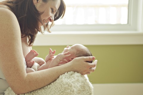Caucasian mother holding newborn baby