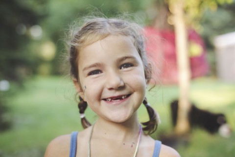 Caucasian girl smiling in backyard