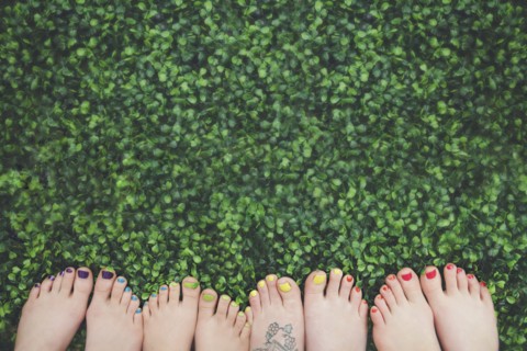 Close up of painted toenails or girls in grass