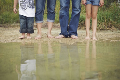 Family wearing jeans at still puddle