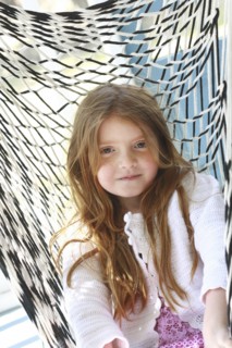 Caucasian girl sitting in hammock