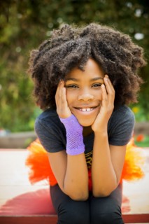 Close up of Black girl sitting on picnic table