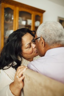 Close up of kissing couple in dining room