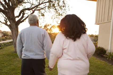 Rear view of couple walking in backyard