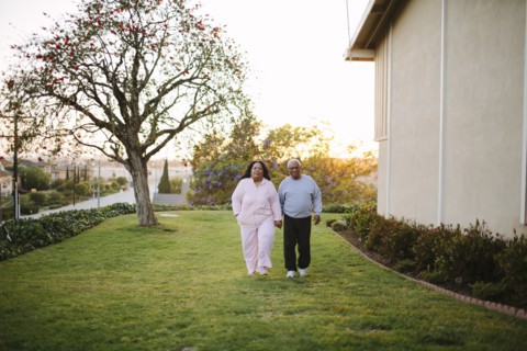Couple walking in backyard of apartment building