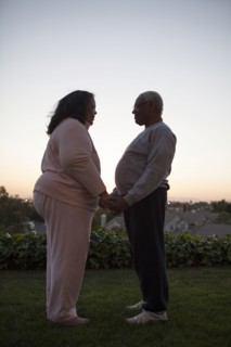 Couple holding hands in backyard