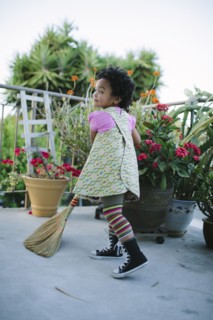Girl sweeping patio with broom