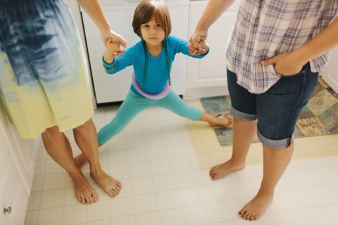 Caucasian family holding hands