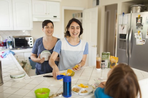 Caucasian family eating breakfast in kitchen