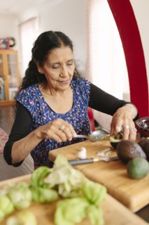 Hispanic woman cooking in kitchen