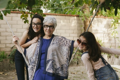 Grandmother and granddaughters playing in backyard