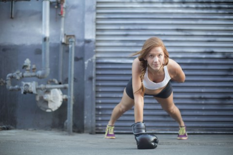 Boxer doing push-ups at warehouse