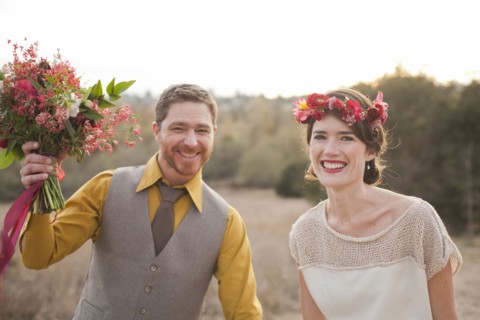 Bride and groom smiling in rural field