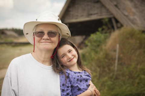 Caucasian grandmother hugging granddaughter in backyard