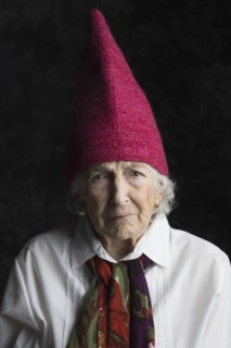 Close up of older woman wearing dunce cap