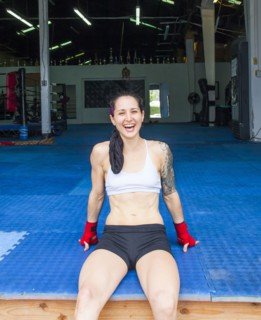 Caucasian boxer laughing in gymnasium