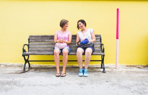 Caucasian women talking on bench
