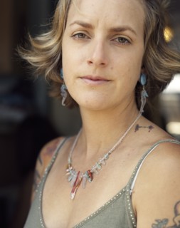 Close up of serious woman wearing jewelry