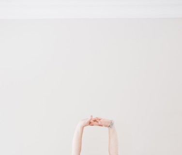 Close up of Caucasian woman stretching arms in midair