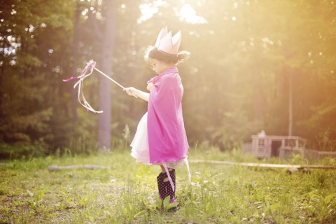 Girl playing princess in backyard