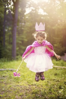 Girl playing princess in backyard