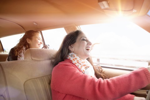 Caucasian mother and daughter driving in car