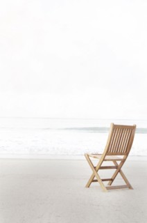 Empty folding chair on beach
