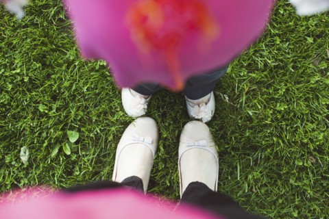 High angle view of feet of mother and daughter in grass