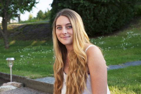 Caucasian teenage girl smiling in park