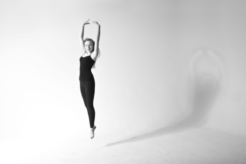 Caucasian dancer jumping for joy