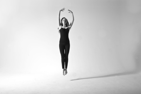 Caucasian dancer jumping for joy