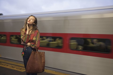 Woman missing passing train in train station