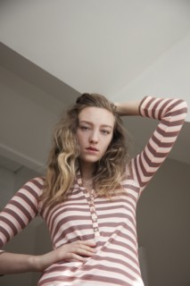 Low angle view of woman posing under gray sky