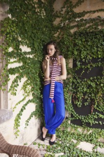 Woman leaning on ivy wall