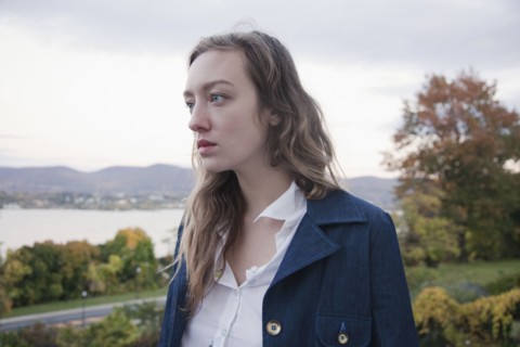 Woman standing in park near lake