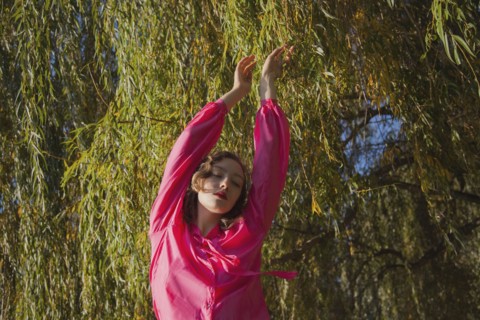 Woman standing under tree in park