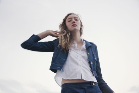 Woman wearing jacket under cloudy sky