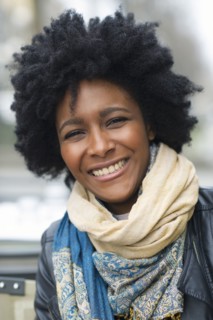 Smiling Black woman wearing scarves