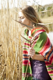 Woman standing in tall plants in marsh