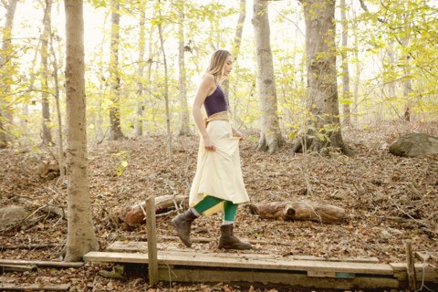 Woman walking on wooden walkway in forest