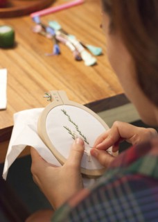 Close up of woman hand-stitching embroidery