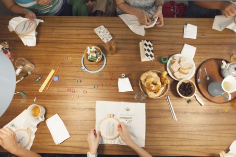 High angle view of women hand-stitching embroidery