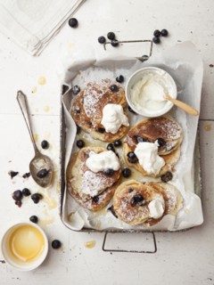 Tray of pancakes with fruit and cream