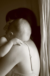 Caucasian mother holding crying baby