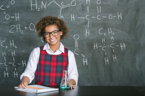 Mixed race student doing experiment in science class