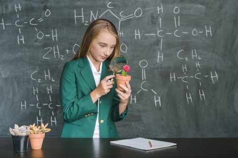 Student examining plant in science class