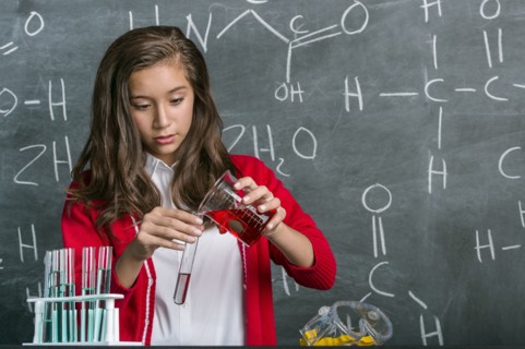 Hispanic student doing experiment in science class