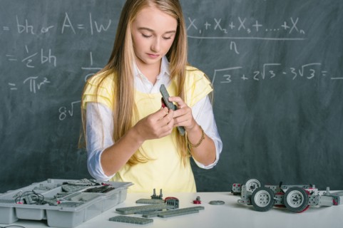 Student building vehicle in science class