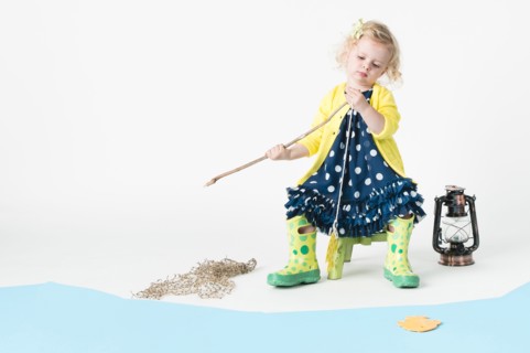 Girl playing fishing with toy fish